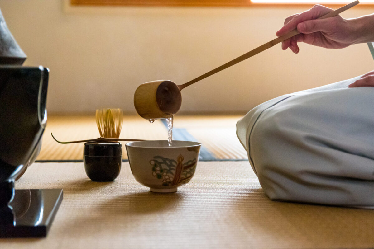 Side view of Japanese woman, tea master, Sen Rikyu, hands using Side view of Japanese woman, tea master, Sen Rikyu, hands using